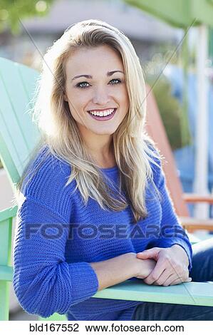 Caucasian woman sitting in deck chair outdoors View Large Photo Image Stock Image - Caucasian woman sitting in deck chair outdoors. Fotosearch