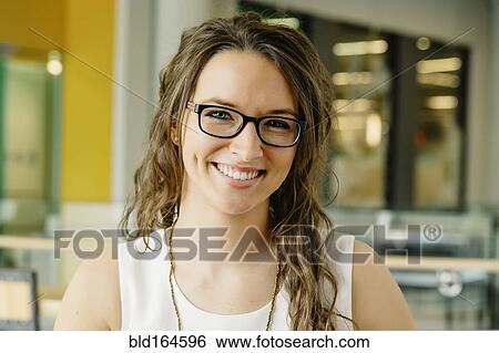 Stock Photograph - Caucasian woman smiling in cafe. Fotosearch