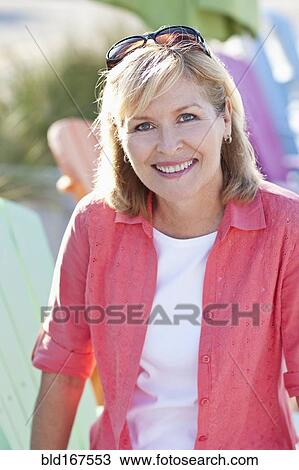 Stock Image - Caucasian woman smiling outdoors. Fotosearch