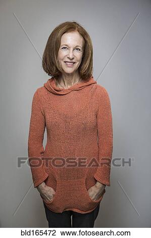 Caucasian woman smiling with hands in pockets View Large Photo Image Stock Image - Caucasian woman smiling with hands in pockets. Fotosearch