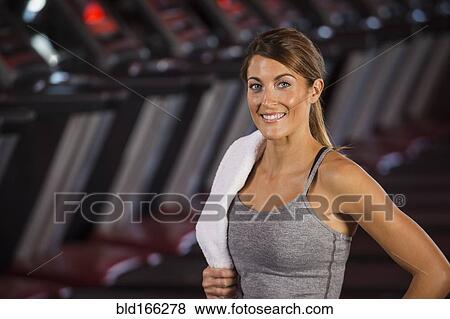 Stock Photo - Caucasian woman standing in gym. Fotosearch