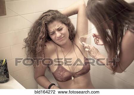 Caucasian woman waxing armpit of friend in bathroom View Large Photo Image Stock Image - Caucasian woman waxing armpit of friend in bathroom. Fotosearch