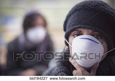 Stock Photo - Caucasian woman wearing protective breathing mask. Fotosearch