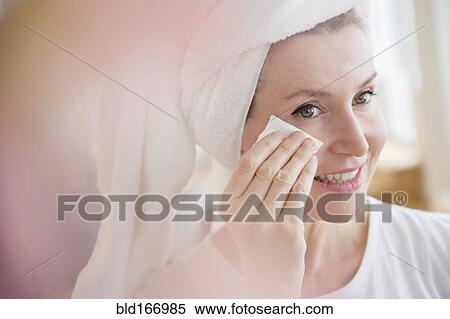 Stock Photography - Caucasian woman wiping face. Fotosearch