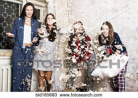 Caucasian women having pillow fight at sleepover View Large Photo Image Stock Image - Caucasian women having pillow fight at sleepover. Fotosearch