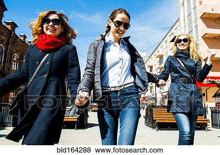 Stock Photo - Caucasian women walking in city. Fotosearch