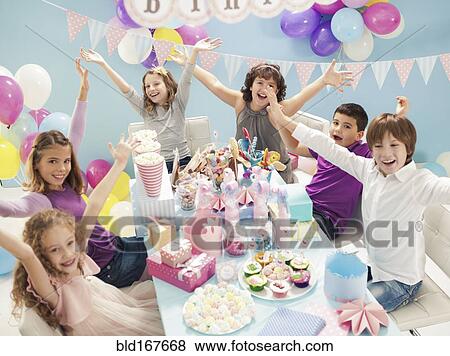 Children cheering at birthday party View Large Photo Image Stock Photo - Children cheering at birthday party. Fotosearch