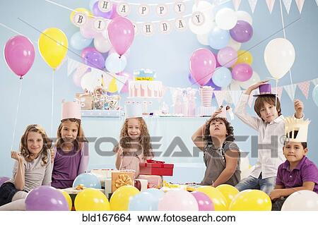 Picture - Children wearing hats at birthday party. Fotosearch