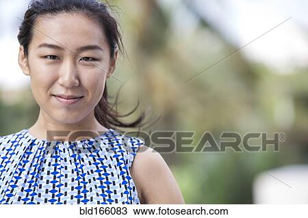 Close up of Asian businesswoman smiling outdoors View Large Photo Image Stock Image - Close up of Asian businesswoman smiling outdoors. Fotosearch