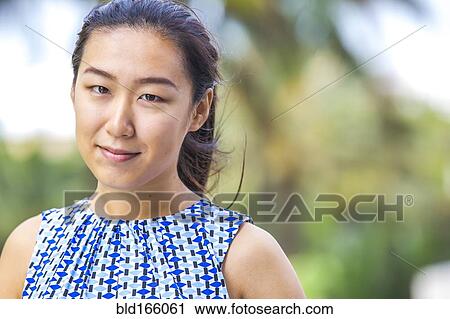 Close up of Asian woman smiling outdoors View Large Photo Image Stock Image - Close up of Asian woman smiling outdoors. Fotosearch