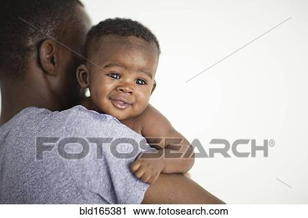 Close up of Black father carrying baby View Large Photo Image Stock Image - Close up of Black father carrying baby. Fotosearch