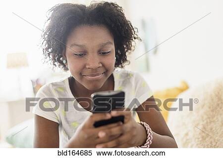 Close up of Black girl using cell phone View Large Photo Image Stock Photography - Close up of Black girl using cell phone. Fotosearch
