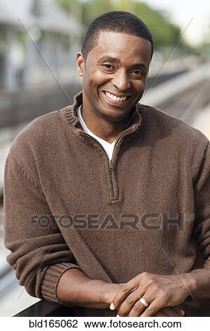 Close up of Black man smiling outdoors View Large Photo Image Stock Image - Close up of Black man smiling outdoors. Fotosearch