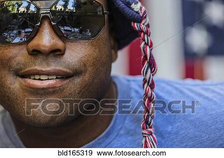 Stock Photo - Close up of Black man wearing sunglasses and knit cap. Fotosearch