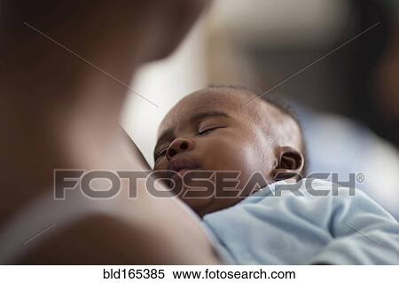 Stock Photography - Close up of Black mother holding baby. Fotosearch