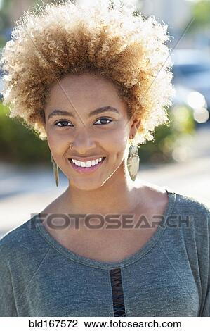Stock Image - Close up of Black woman smiling outdoors. Fotosearch