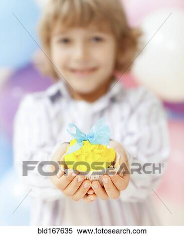 Close up of boy holding decorated cupcake View Large Photo Image Stock Photography - Close up of boy holding decorated cupcake. Fotosearch