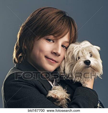 Close up of boy in suit holding dog View Large Photo Image Stock Image - Close up of boy in suit holding dog. Fotosearch