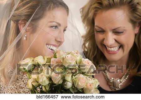 Close up of bride and maid of honor laughing View Large Photo Image Stock Photo - Close up of bride and maid of honor laughing. Fotosearch