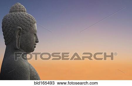 Close up of Buddha statue under sunset sky View Large Photo Image Stock Image - Close up of Buddha statue under sunset sky. Fotosearch