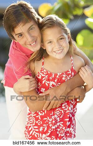 Stock Photograph - Close up of Caucasian brother and children hugging. Fotosearch