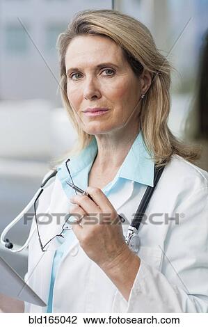 Stock Image - Close up of Caucasian doctor using digital tablet. Fotosearch