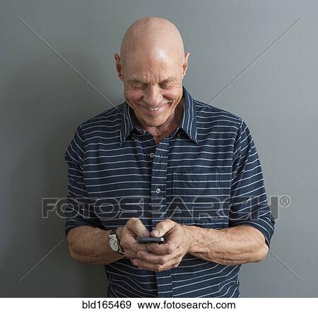 Stock Photo - Close up of Caucasian man using cell phone. Fotosearch