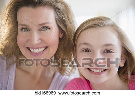 Close up of Caucasian mother and daughter smiling View Large Photo Image Stock Photo - Close up of Caucasian mother and daughter smiling. Fotosearch