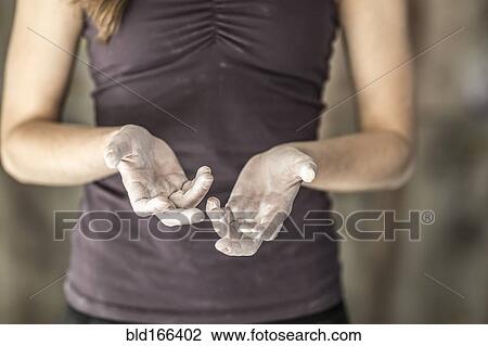 Stock Image - Close up of chalky hands of athlete in gym. Fotosearch