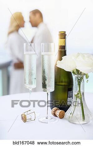 Close up of champagne glasses on balcony table View Large Photo Image Stock Photo - Close up of champagne glasses on balcony table. Fotosearch