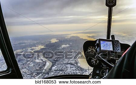 Stock Image - Close up of controls in airplane flying over New York, New York, United States. Fotosearch