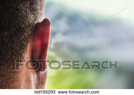 Close up of ear of Caucasian man and sound waves View Large Photo Image Stock Image - Close up of ear of Caucasian man and sound waves. Fotosearch