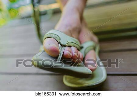 Close up of feet of man wearing flipflops View Large Photo Image Stock Image - Close up of feet of man wearing flipflops. Fotosearch