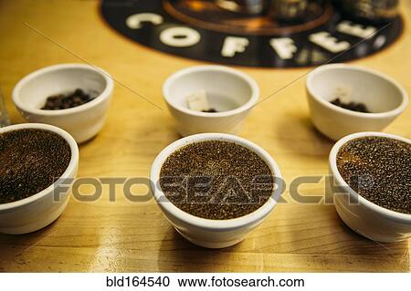 Stock Image - Close up of fresh ground coffee in tasting cups. Fotosearch