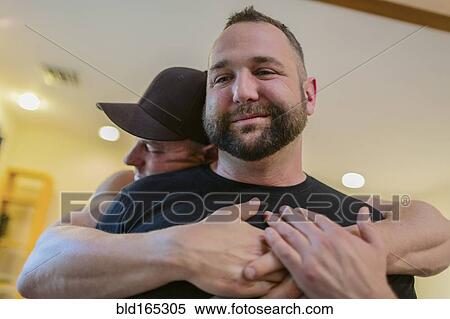 Close up of gay couple hugging View Large Photo Image Stock Photography - Close up of gay couple hugging. Fotosearch