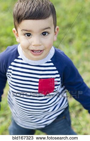 Stock Image - Close up of Hispanic boy outdoors. Fotosearch