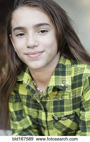 Stock Photo - Close up of Hispanic girl wearing plaid shirt. Fotosearch