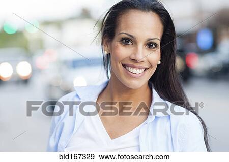 Close up of Hispanic woman smiling outdoors View Large Photo Image Stock Photo - Close up of Hispanic woman smiling outdoors. Fotosearch