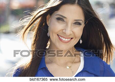 Close up of Hispanic woman smiling outdoors View Large Photo Image Stock Photography - Close up of Hispanic woman smiling outdoors. Fotosearch