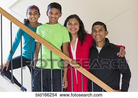 Picture - Close up of Indian family smiling on staircase. Fotosearch