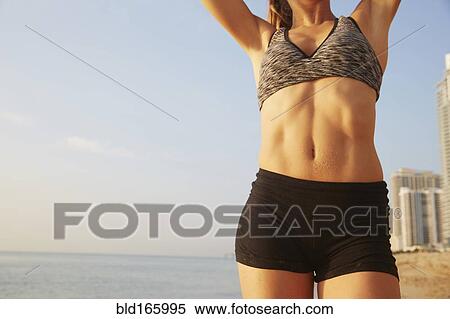 Close up of midsection of athlete on beach View Large Photo Image Stock Photography - Close up of midsection of athlete on beach. Fotosearch