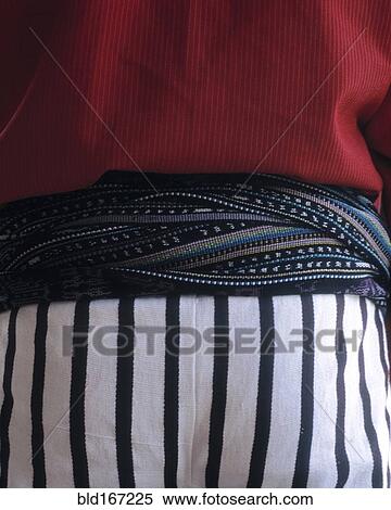 Stock Photography - Close up of midsection of person wearing traditional clothing. Fotosearch