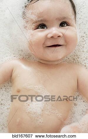 Stock Photo - Close up of mixed race baby in bubble bath. Fotosearch