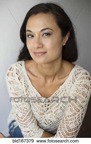 Stock Photo - Close up of mixed race woman smiling. Fotosearch