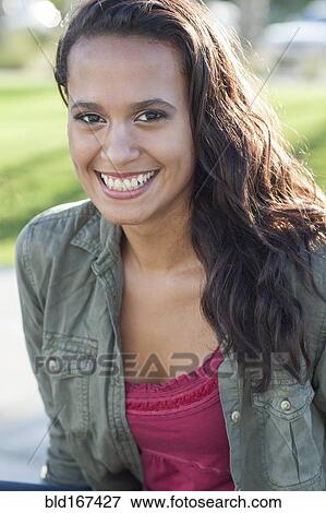 Close up of mixed race woman smiling outdoors View Large Photo Image Stock Photo - Close up of mixed race woman smiling outdoors. Fotosearch