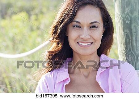 Stock Photography - Close up of mixed race woman smiling outdoors. Fotosearch