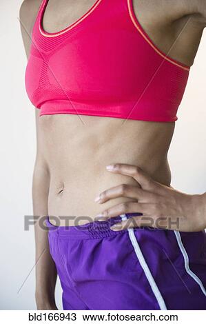 Stock Image - Close up of mixed race woman wearing sportswear. Fotosearch