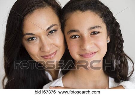 Close up of mother and daughter hugging View Large Photo Image Stock Photograph - Close up of mother and daughter hugging. Fotosearch