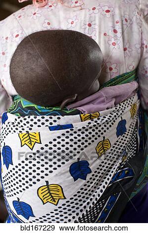 Close up of mother carrying baby with traditional wrap View Large Photo Image Stock Photo - Close up of mother carrying baby with traditional wrap. Fotosearch