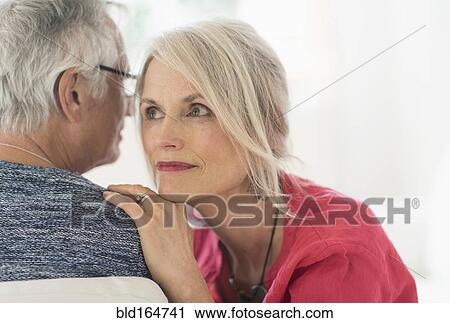 Close up of older Caucasian couple whispering View Large Photo Image Stock Image - Close up of older Caucasian couple whispering. Fotosearch